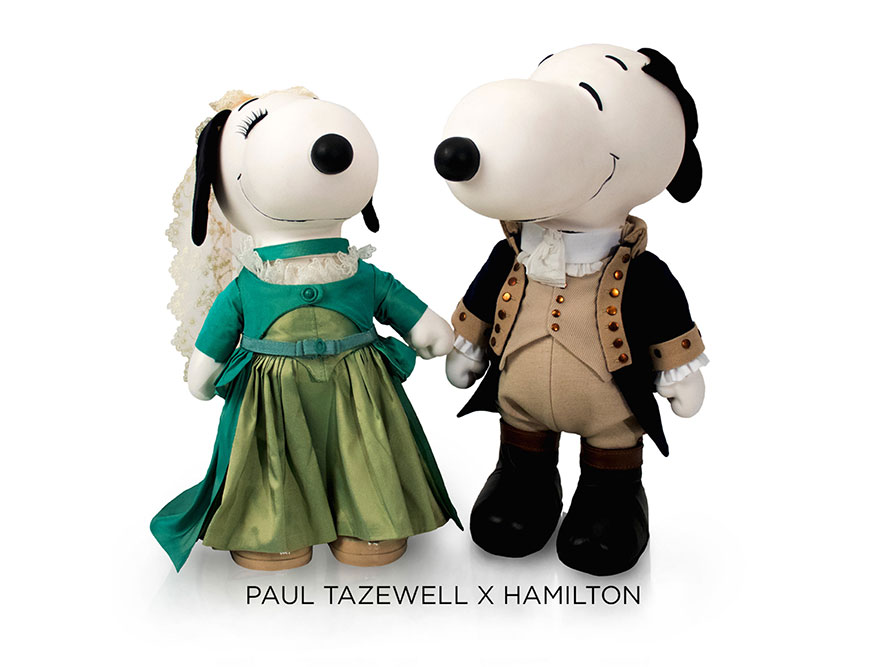 Two black and white dog statues in front of a white background. The dog on the left is wearing a green gown and a veil. The dog on the right is wearing a black tuxedo and a beige vest.