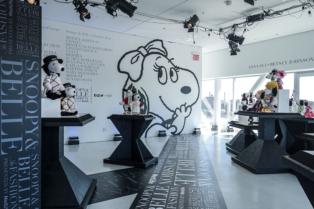 A bright, indoor space displaying small  black and white dog statues.