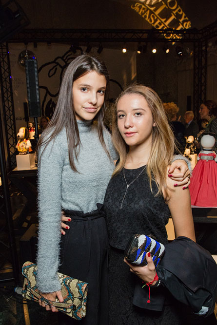 Two teenage girls posing for a picture at an event.