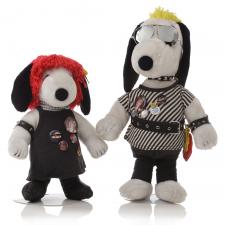 Two black and white dog statues in front of a white background. The dog on the left has a red wig and is wearing a black dress. The dog on the right is wearing a striped, black and white shirt, aviator sunglasses and a black leather belt.