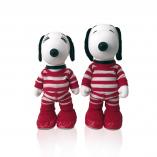 Two black and white dog statues in front of a white background wearing red and white striped outfits.