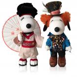 Two black and white dog statues in front of a white background. The dog on the left is wearing a Japanese kimono and holding an umbrella. The dog on the right is wearing an orange wig, a dark blue tuxedo and a black top hat.