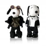 Two black and white dog statues in front of a white background. The dog on the left is wearing sunglasses, black pants, brown blouse and a black jacket. The dog on the right is wearing black jeans, a white shirt and a black jacket.