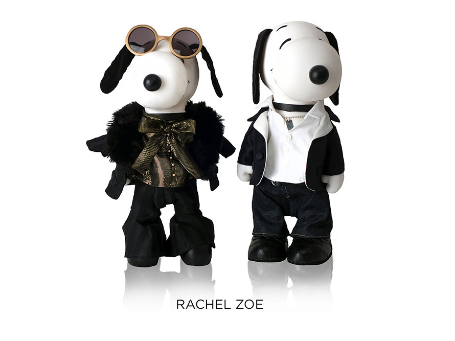 Two black and white dogs statues in front of a white background. The dog on the left is wearing sunglasses and a fur coat and the dog on the right is wearing a white collar shirt, jeans and a black sweater.