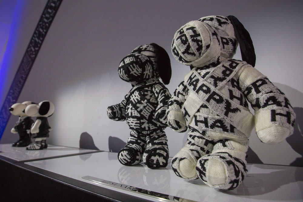 A low angle view of two dog statues on display, wrapped up in black and white fabric.
