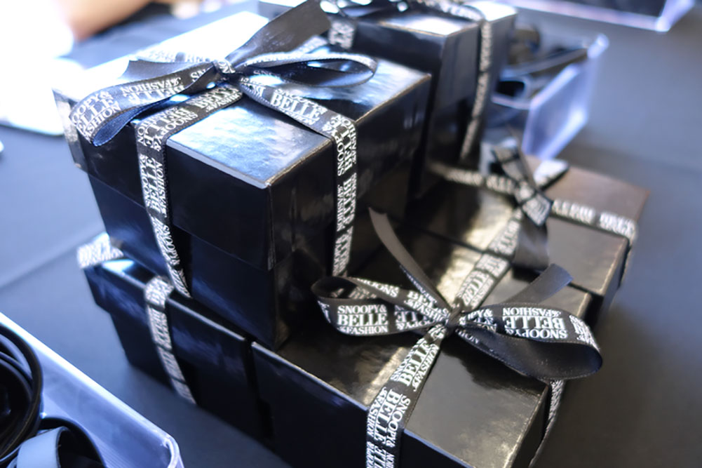 A few black gift boxes sitting on a table.