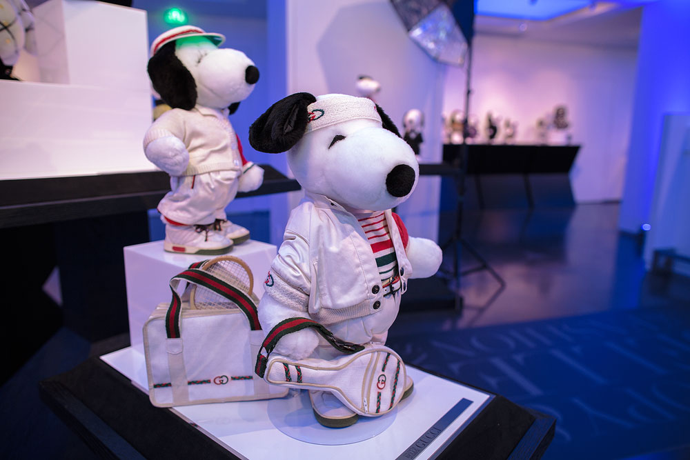 A close-up of two black and white dog statues on display, wearing designer, tennis uniforms.
