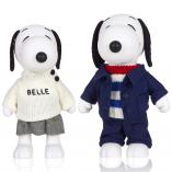 Two black and white dog statues in front of a white background. The dog on the left is wearing a beige top and grey shorts and the dog on the right is wearing blue pants, jacket and blue and white striped shirt.