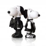 Two black and white dog statues standing back-to-back in front of a white background. They are both wearing black outfits.