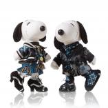 Two black and white dog statues in front of a white background wearing black and blue outfits. 