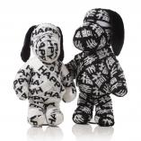 Two black and white dog statues wrapped in black and white fabric in front of a white background.